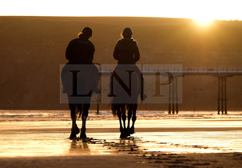 © Licensed to London News Pictures. <br />
29/09/2016. <br />
Saltburn-by-the-Sea, UK. <br />
<br />
Two women exercise their horses on the beach at sunrise at Saltburn by the Sea.<br />
<br />
Photo credit: Ian Forsyth/LNP