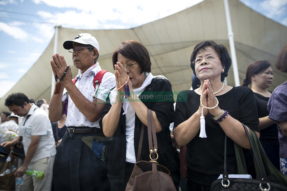 August 9, 2016 - Nagasaki, Nagasaki Prefecture, Japan - NAGASAKI, JAPAN - AUGUST 9 : Visitors pray for the atomic bomb victims in front of the Peace Statue during the 71st Anniversary of atomic bombing on Nagasaki at Nagasaki Peace Park, Nagasaki, southern Japan, Tuesday, August 9, 2016. Japan marked the 71st anniversary of the atomic bombing on Nagasaki. On August 9, 1945, during World War II, the United States dropped the second Atomic bomb on Nagasaki city, killing an estimated 40,000 people which ended World War II. (Credit Image: © Richard Atrero De Guzman/NurPhoto via ZUMA Press)