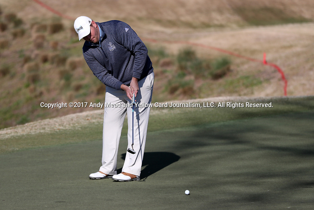 WILMINGTON, NC - MARCH 19: UNC Wilmington's Austin Inman putts on the Ocean Course fourth hole. The first round of the 2017 Seahawk Intercollegiate Men's Golf Tournament was held on March 19, 2017, at the Country Club of Landover Nicklaus Course in Wilmington, NC.