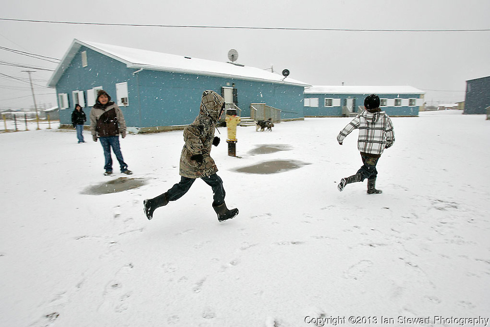 Children play in the yard of the makeshift elementary school, composed of portable classrooms. The previous elementary school building was contaminated with diesel fuel and was closed in 2000. The community has been pleading with the Canadian government for a new school for over a decade. <br />
<br />
(Ian Stewart photo)