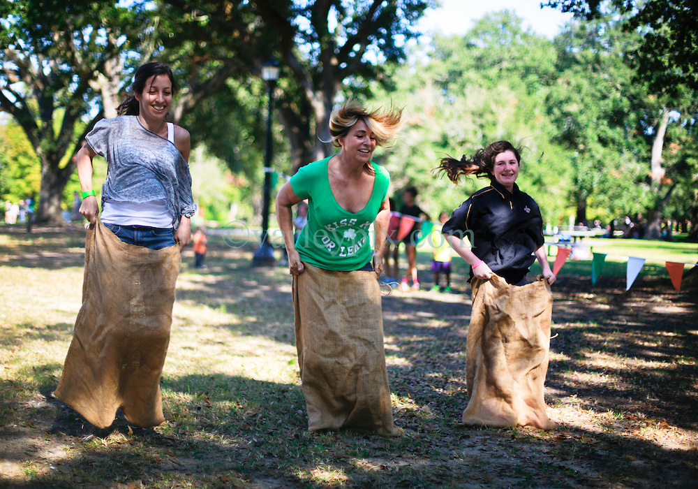 19 October 2014. New Orleans, Louisiana. <br />
Sack racing ladies at the New Orleans' Irish Network's third Family Day event with fun and games for kids and adults alike. With Irish dancing, egg and spoon and sack races with a good old fashioned tug of war to round things off.<br />
Photo; Charlie Varley/varleypix.com