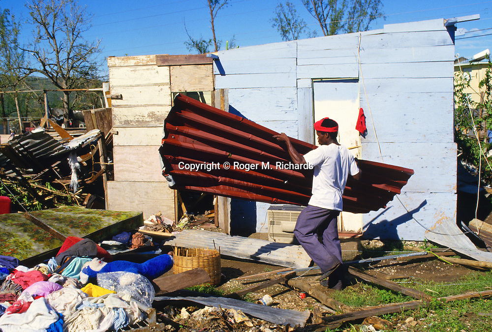 A Kingston resident clears up damage to his home in September 1988 after Hurricane Gilbert hit Jamaica. By the time the destruction had stopped, 45 people were dead and over 500,000 left homeless. Agriculture was devastated, with US$50 million in damage to coffee, sugar cane, banana and other crops. Looting was widespread, particularly in Kingston. Foreign aid of about US$125 million form the USA alone poured into the stricken island. The tourist parts of the island were returned to normal with remarkable speed, but others took much longer to recover from the devastation.