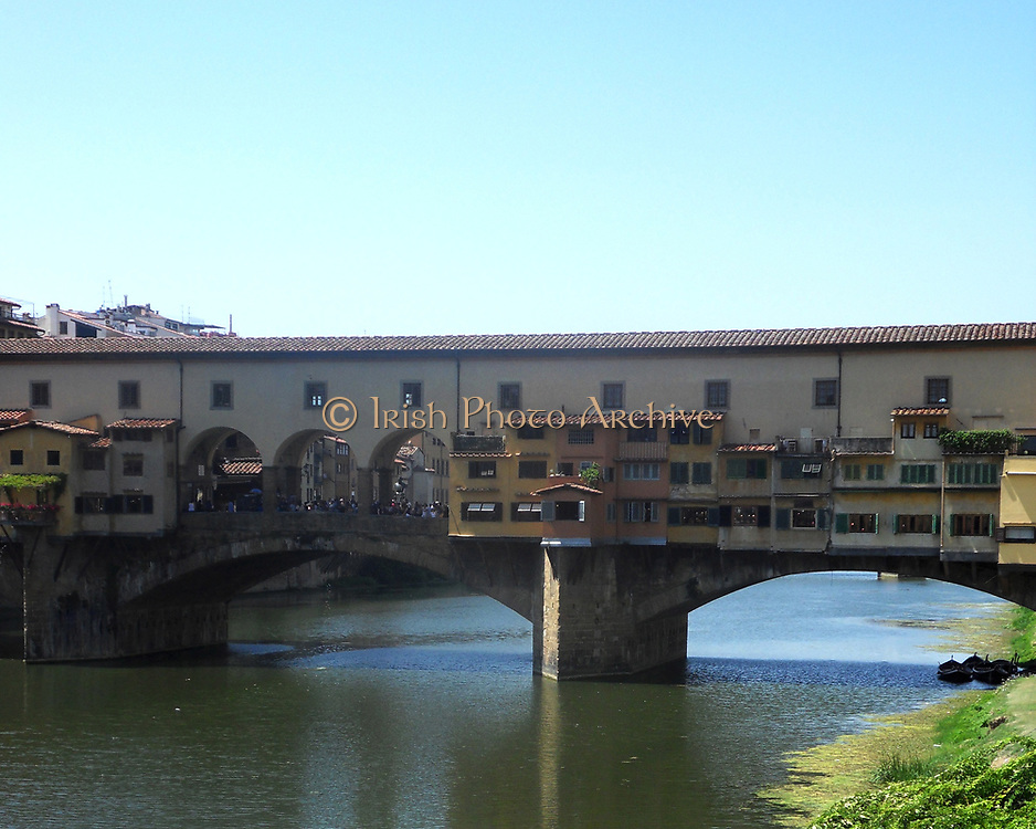 The Ponte Vecchio medieval stone closed-spandrel segmental arch bridge over the Arno River, in Florence, Italy, noted for still having shops built along it, as was once common. It was rebuilt in 1345
