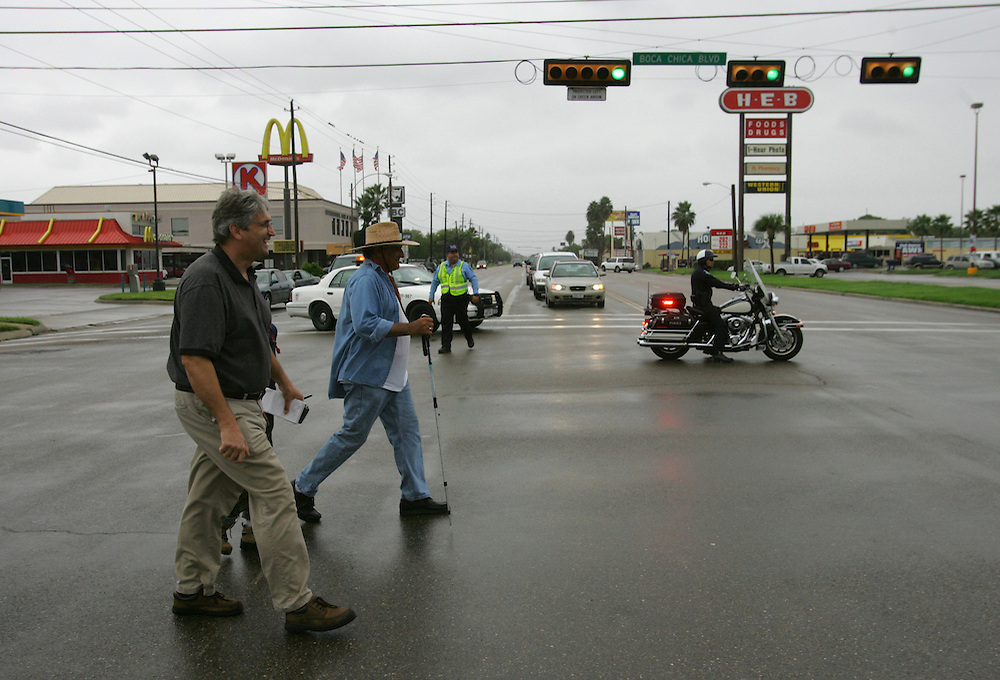 Brownsville Police officers block the intersection of Boca Chica and Central so Jay Johnson Castro and his supporters can walk through on Wednesday, the final day of the protest walk. Reporter Steve Taylor is at left.