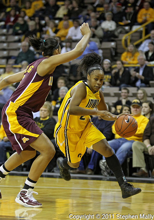 February 10 2011: Iowa Hawkeyes guard Kachine Alexander (21) drives around Minnesota Golden Gophers forward Kionna Kellogg (5) during the first half of an NCAA women's college basketball game at Carver-Hawkeye Arena in Iowa City, Iowa on February 10, 2011. Iowa defeated Minnesota 64-62.
