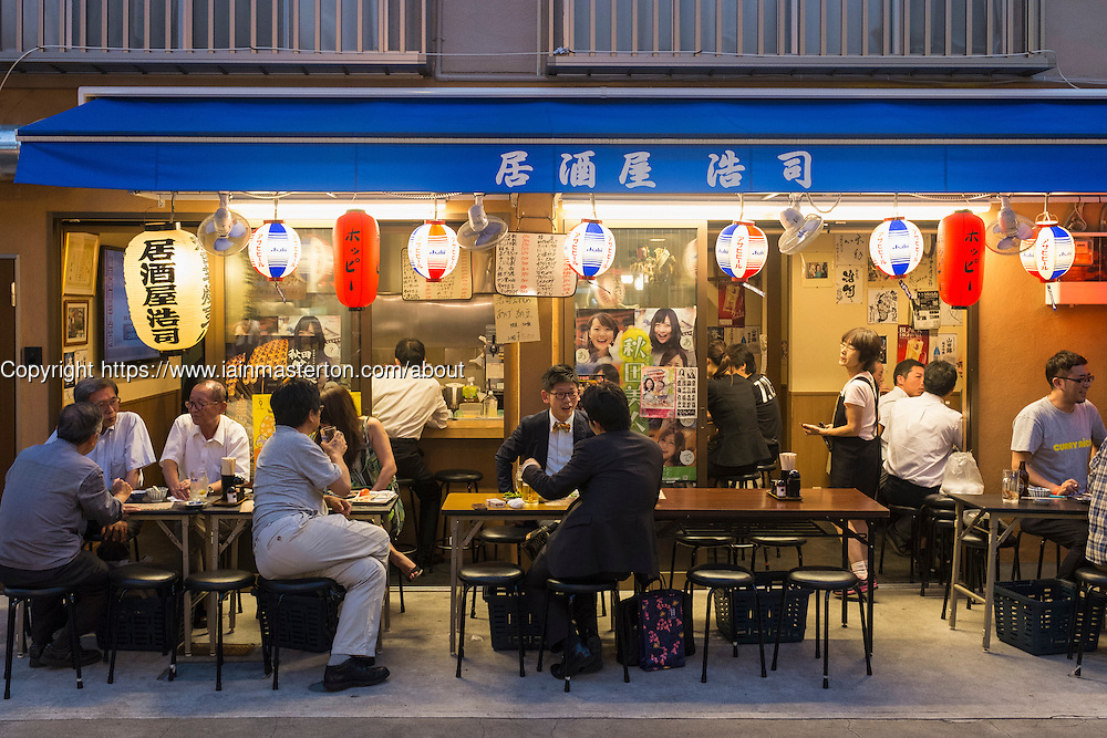 Small outdoor restaurant on street in the evening in Rokku entertainment district of Asakusa adjacent to SensoJi shrine in Tokyo Japan