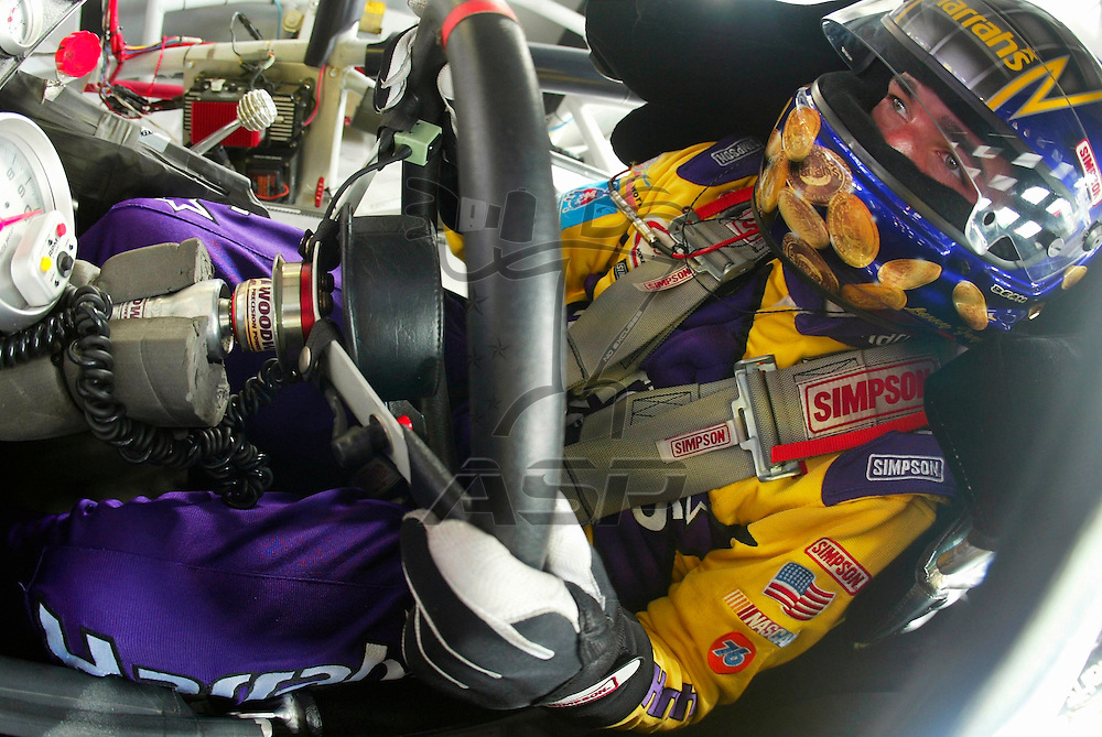 Larry Foyt waits for his crew to make some minor adjustments to his Harrah's Dodge during a practice session for the running of the Banquet 400 NASCAR Winston Cup race at the Kansas Speedway in Kansas City, KS.