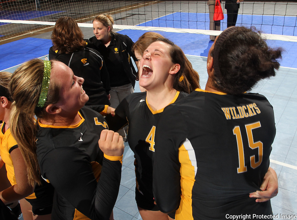 Janesville's Shelby Murley (5), Karli Kruse (4), and Olivia Fisher (15) celebrate their win following the fourth game of their 1A semifinal match in the state volleyball tournament at the U.S. Cellular Center at 370 1st Ave E on Friday evening, November 12, 2010. (Stephen Mally/Freelance)
