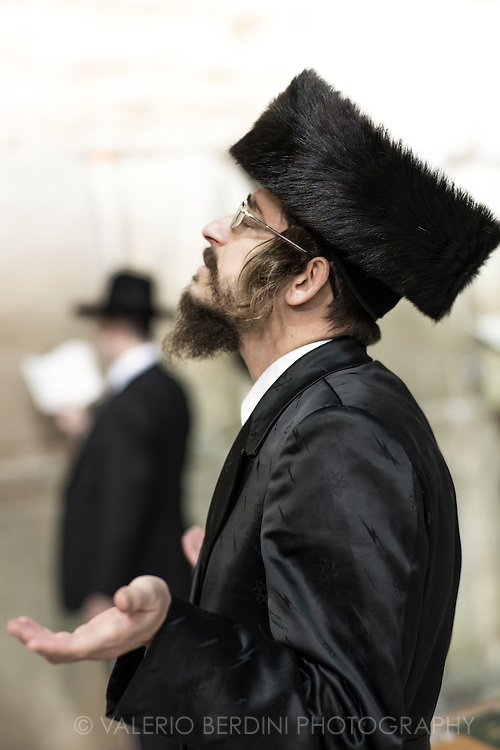 A Haredim in Shabbat close with traditional bekishe coat and shtreimel fur hat. The bekishe is a long coat usually made of black silk worn by Hasidic Jews, and by some non-Hasidic Haredi Jews.<br />
The bekishe is worn mainly on Shabbat and Jewish holidays, or at weddings and other such events. Shtreimel is a fur hat worn by many married haredi Jewish men on Shabbat. To Jewish law there is no special religious significance to the shtreimel as compared to other head coverings. However, the wearing of two head coverings is considered to add additional spiritual merit. The shtreimel is always worn over a kippah, or yarmulke.