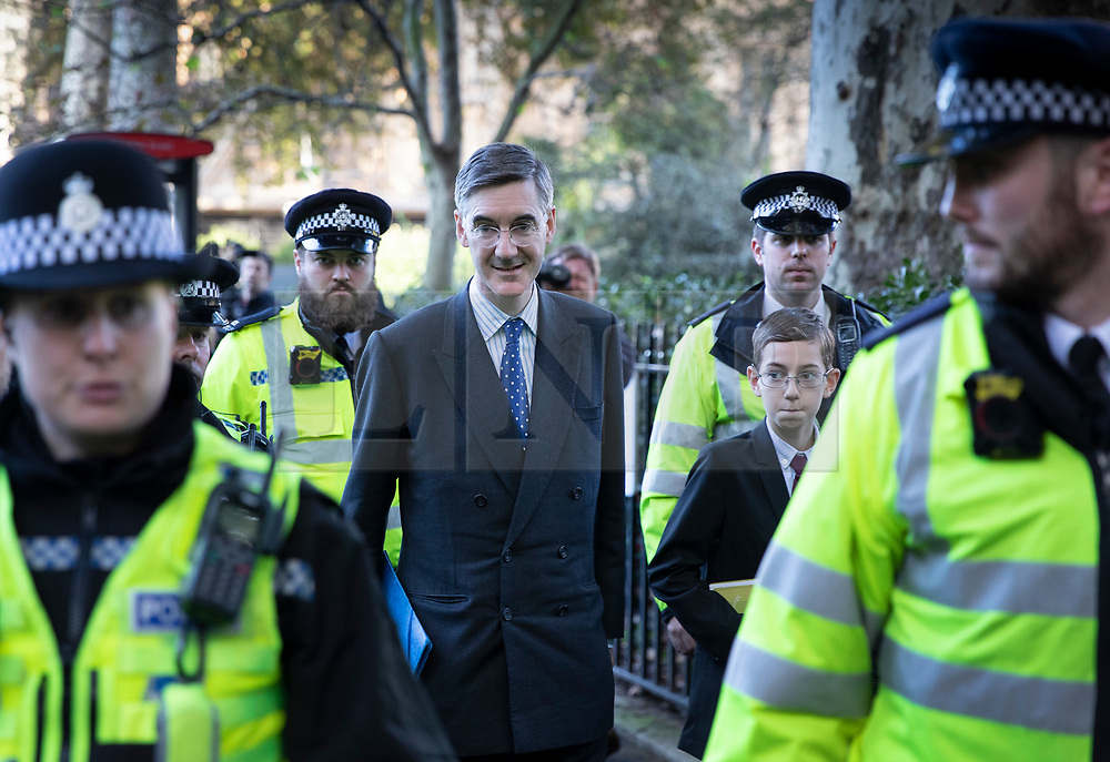 © Licensed to London News Pictures. 19/10/2019. London, UK. Jacob Reese Mogg and his son (R) leave Parliament surrounded by police after MPs voted for a Brexit deal delay. The Prime Minister's new Brexit deal is being debated and voted on in an historic Saturday sitting in The House of commons today. Photo credit: Peter Macdiarmid/LNP