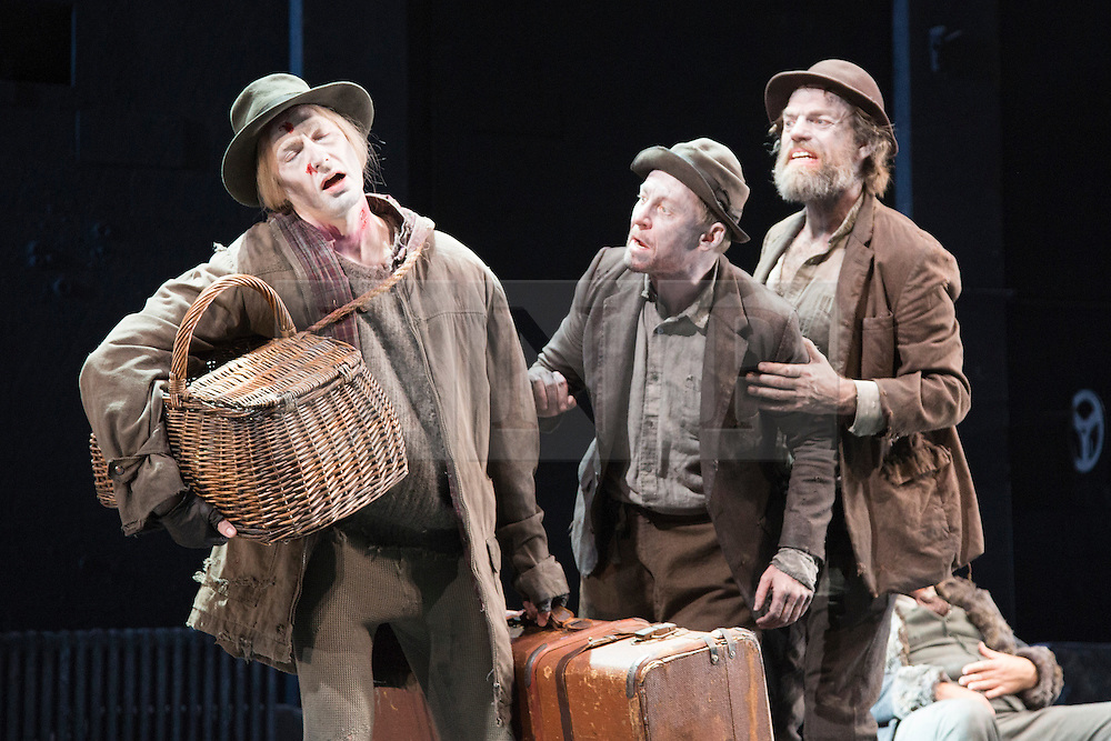 © Licensed to London News Pictures. 05/06/2015. London, UK. L-R: Luke Mullins as Lucky, Richard Rockburgh as Estragon and Hugo Weaving as Vladimir. Actors Richard Roxburgh and Hugo Weaving star in Samuel Beckett's "Waiting for Godot" at the Barbican Theatre. Part of the International Beckett Season, this Sydney Theatre Company play is directed by Andrew Upton. With Luke Mullins as Luke, Philip Quast as Pozzo, Richard Roxburgh as Estragon and Hugo Weaving as Vladimir. Performances from 4 to 13 June 2015 at the Barbican Theatre. Photo credit : Bettina Strenske/LNP