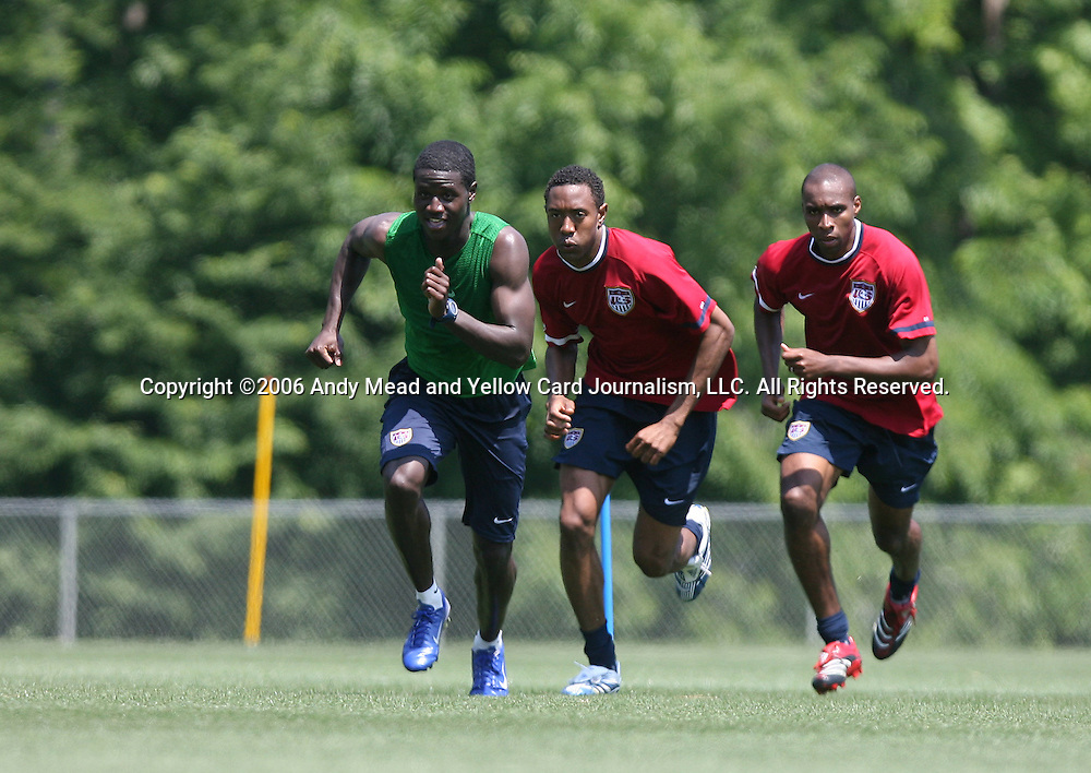 Eddie Johnson (l) leads Cory Gibbs (center) and Eddie Pope (r) in a fitness exercise on Wednesday, May 17th, 2006 at SAS Soccer Park in Cary, North Carolina. The United States Men's National Soccer Team held a training session as part of their preparations for the upcoming 2006 FIFA World Cup Finals being held in Germany.