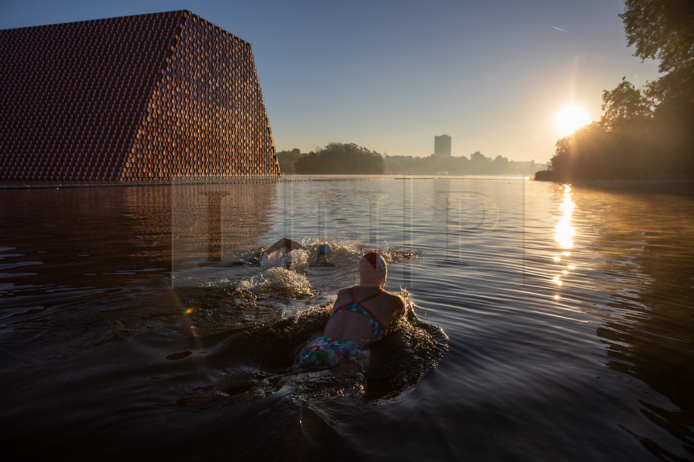 © Licensed to London News Pictures. 27/09/2018. London, UK. Swimmers enter the Serpentine Lido in Hyde Park at sunrise this morning. The temperature in the capital is set to reach 22 degrees Celsius later today. Photo credit : Tom Nicholson/LNP
