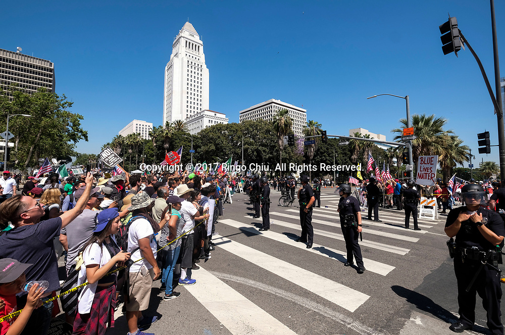 Police officers separate the May Day protesters, left, and a group of President Donald Trump supporters as they taunt each other during the annual May Day March in Los Angeles, May 1, 2017. (Photo by Ringo Chiu/PHOTOFORMULA.com)<br />
<br />
Usage Notes: This content is intended for editorial use only. For other uses, additional clearances may be required.