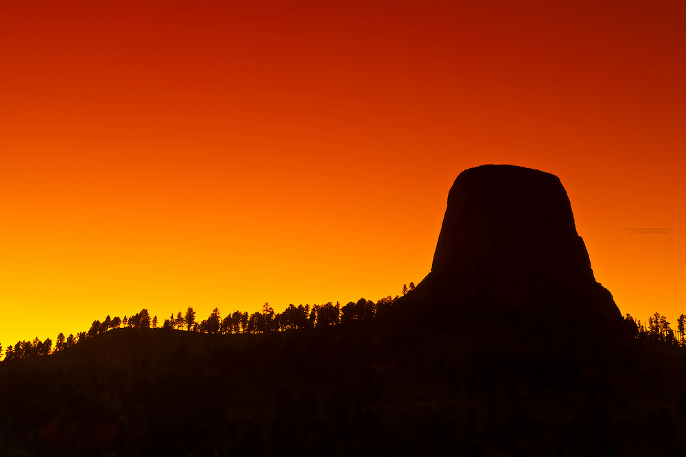 The 867 foot tall Devils Tower (a granite monolith which is a sacred site to American Indians) at sunset, Devils Tower National Monument, Wyoming USA