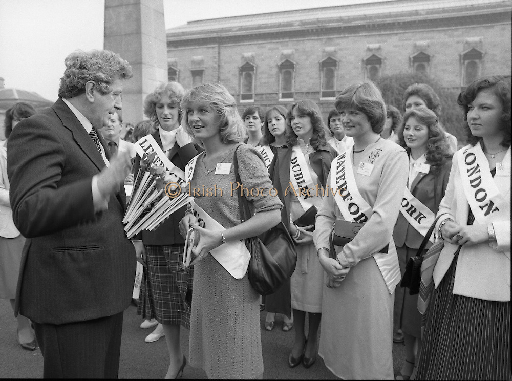 An Taoiseach Meets The Roses Of Tralee. (N90)..1981..28.08.1981..08.28.1981..28th August 1981..An Taoiseach, Garret Fitzgerald, met with the contestants of The Rose Of Tralee Festival when they were invited to Government Buildings, Leinster House, Dublin...Image shows the Toronto Rose accepting a rose and booklet from An Taoiseach, Garret Fitzgerald as the other Roses look on.