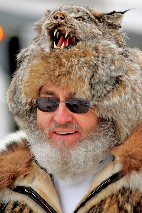 Fur hats, parkas, and warm smiles are worn by Eagle River resident Russ Wilmot, who volunteers each year at the ceremonial start of the Iditarod in downtown Anchorage. Over 1,800 volunteers assist in the Iditarod effort in Anchorage and throughout the state.