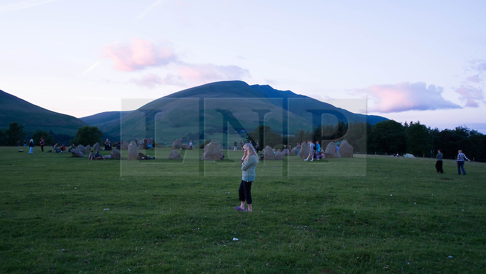 © Licensed to London News Pictures. <br />
20/06/2014. <br />
<br />
Castlerigg Stone circle, Cumbria, England<br />
<br />
Visitors to the ancient site of Castlerigg Stone Circle near Keswick in Cumbria come together to celebrate on the evening of the Summer Solstice.<br />
<br />
Photo credit : Ian Forsyth/LNP