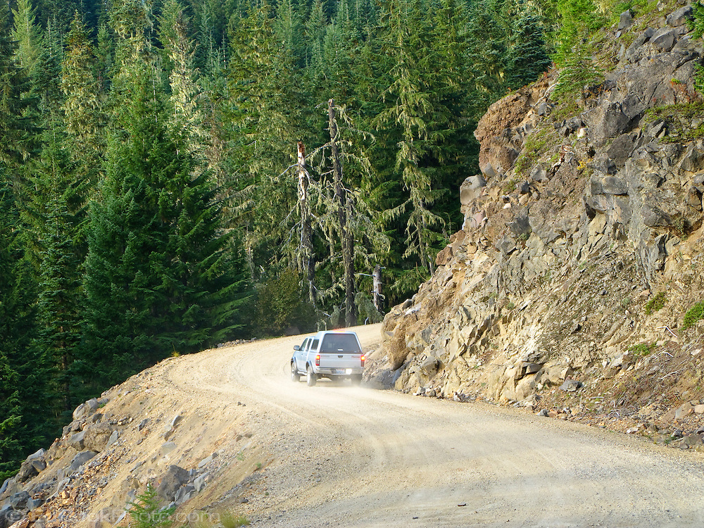A pickup truck plies the dusty dirt Gifford Pinchot Forest Service Road 23 near Mount Adams north of Trout Lake, WA, USA