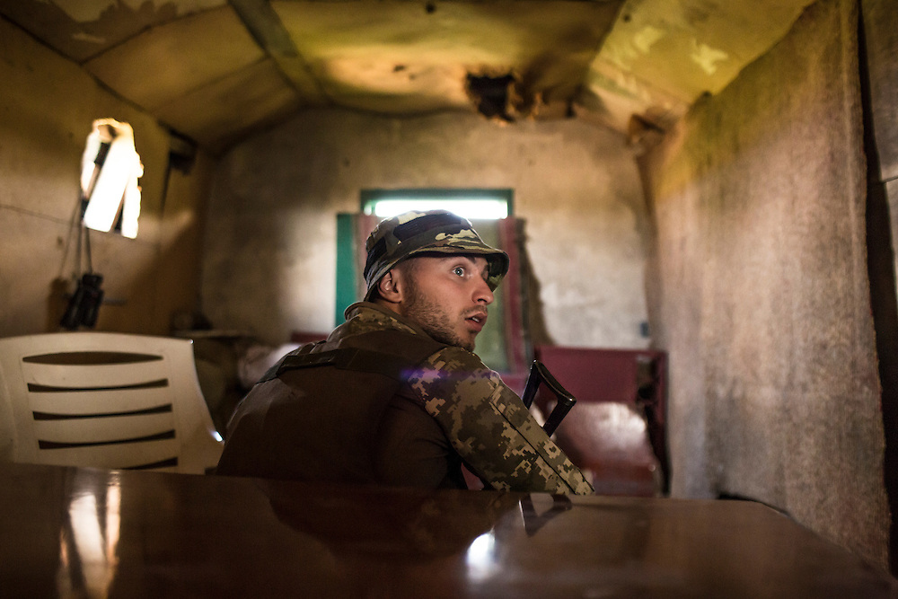 AVDIIVKA, UKRAINE - JULY 9, 2016: Lt. Denis Naumov, a Ukrainian Army press officer with the 58th brigade, in the attic of a house that was just by sniper fire in Avdiivka, Ukraine. The town is now one of the most active areas of fighting along the line of control between the Ukrainian government and Russian-backed rebels. CREDIT: Brendan Hoffman for The New York Times