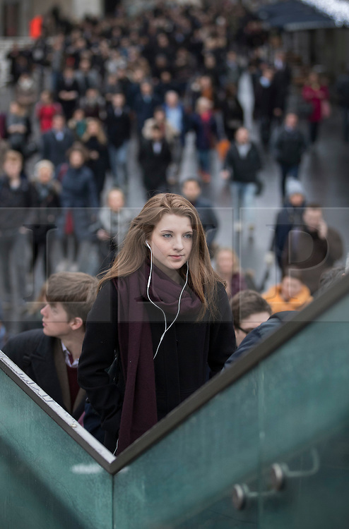 © Licensed to London News Pictures. 09/01/2017. London, UK. Commuters climb the steps to The Golden Jubilee footbridge as they cross the Thames on foot as a 24 hour London Underground tube strike takes hold. All Zone one tube stations are closed until 6PM tonight after members of the RMT and the Transport Salaried Staffs' Association unions walked out after talks with TFL collapsed. Photo credit: Peter Macdiarmid/LNP