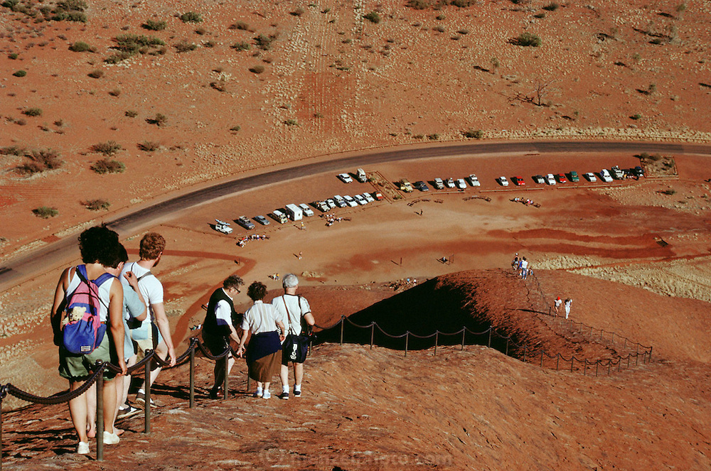 Tourists make the descent from Ayer's Rock (Yulara). Central Australia.