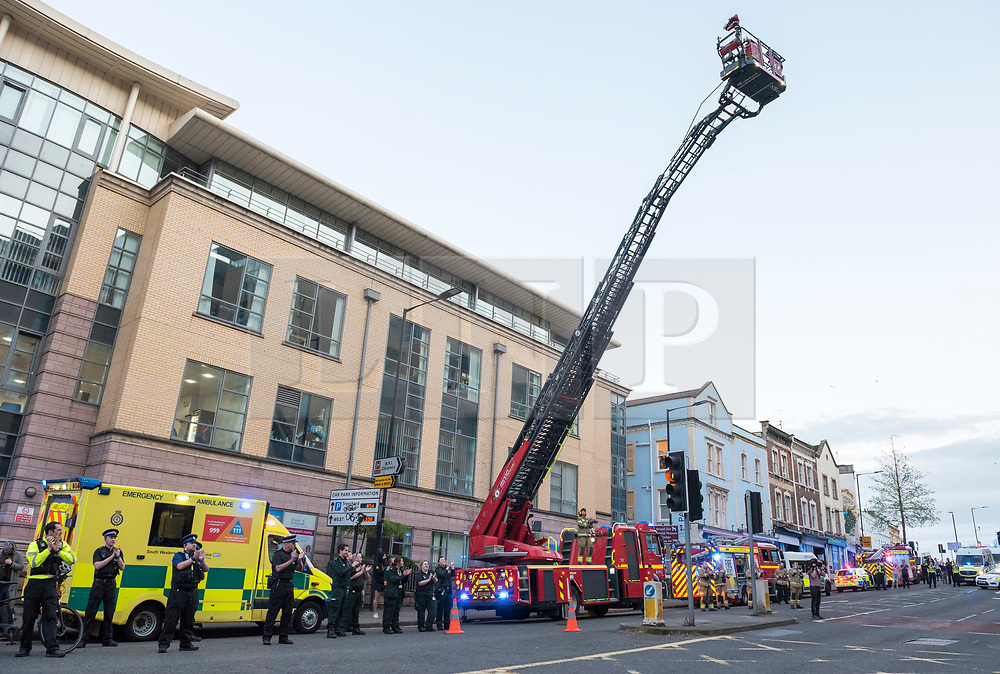 © Licensed to London News Pictures; 16/04/2020; Bristol, UK. A fire engine turntable ladder is extended and members of the emergency services and the public clap at 8pm on Thursday evening outside the Bristol Royal Infirmary hospital to applaud NHS health service workers during the coronavirus Covid-19 pandemic. Today the UK recorded another 861 coronavirus deaths in hospital, taking the total to 13,729, with a total of 103,093 people who have tested positive for the virus. There is a UK wide lockdown with the biggest restrictions on freedom of movement ever imposed in the UK. Photo credit: Simon Chapman/LNP.
