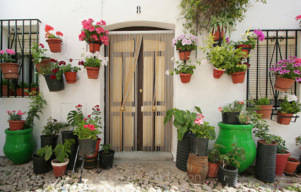 A typical Spanish village house with flower pots.