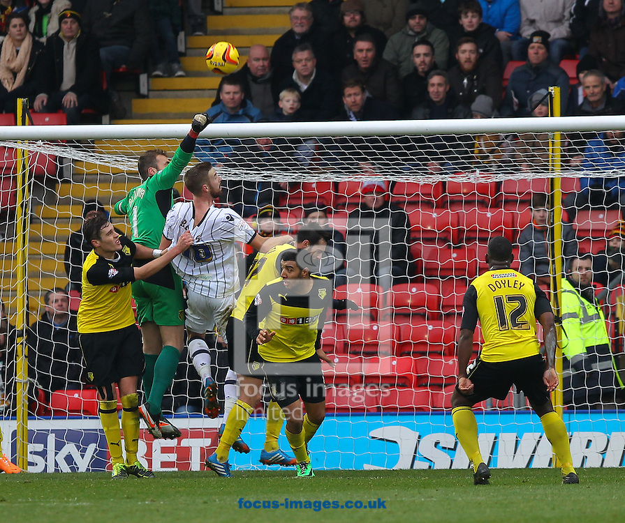 Picture by John Rainford/Focus Images Ltd +44 7506 538356<br />
26/12/2013<br />
Manuel Almunia of Watford and his defence make sure Mark Bevers of Millwall doesn't get to a corner during the Sky Bet Championship match at Vicarage Road, Watford.