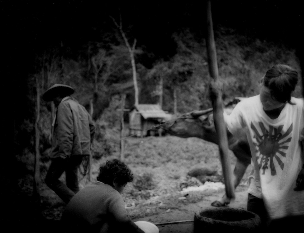 Girl, the daughter of a Filipino man and a Negrito woman, pounds rice, Sawa, Sierra Madre Mountains, Luzon, Philippines. Intermarriage is not uncommon between Negritos and Filipinos.