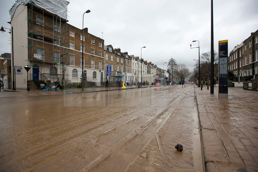 © Licensed to London News Pictures. 28/02/2014. London, UK. Water and debris are seen on Clapham Road in Kennington, London today (28/02/2014) after a watermain burst yesterday evening. The flooding, along one of the main routes in and out of the centre of the city, has today caused widespread disruption to traffic. Photo credit: Matt Cetti-Roberts/LNP