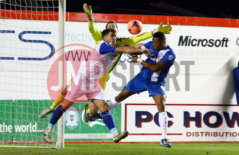 Peterborough United's Britt Assombalonga in action with Tranmere Rovers' Ryan Edwards and Tranmere Rovers' Owain Fon Williams - Photo mandatory by-line: Joe Dent/JMP - Tel: Mobile: 07966 386802 07/12/2013 - SPORT - Football - Peterborough - London Road Stadium - Peterborough v Tranmere - FA Cup - Second Round