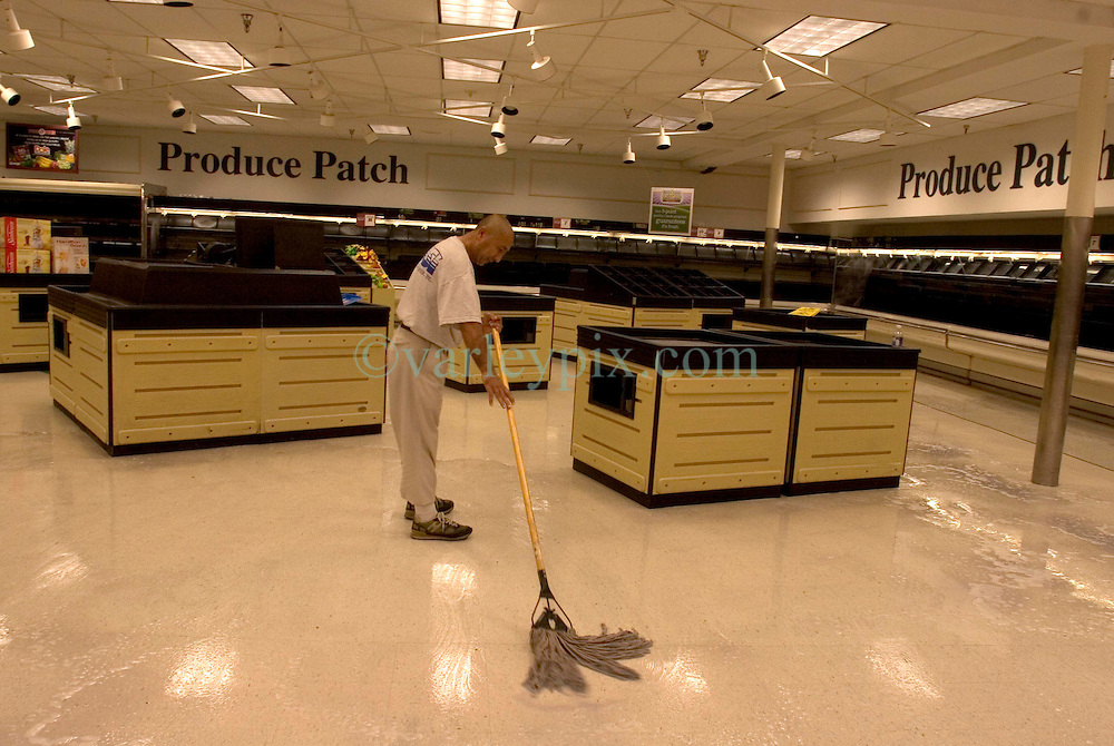30 Sept, 2005. New Orleans, Louisiana. Hurricane Katrina aftermath. <br />
Disaster recovery private contractors pressure wash and bleach clean the Winn Dixie supermarket in Uptown New Orleans as businesses and locals return to the city. The supermarket hopes to open on October 6th.<br />
Photo; ©Charlie Varley/varleypix.com