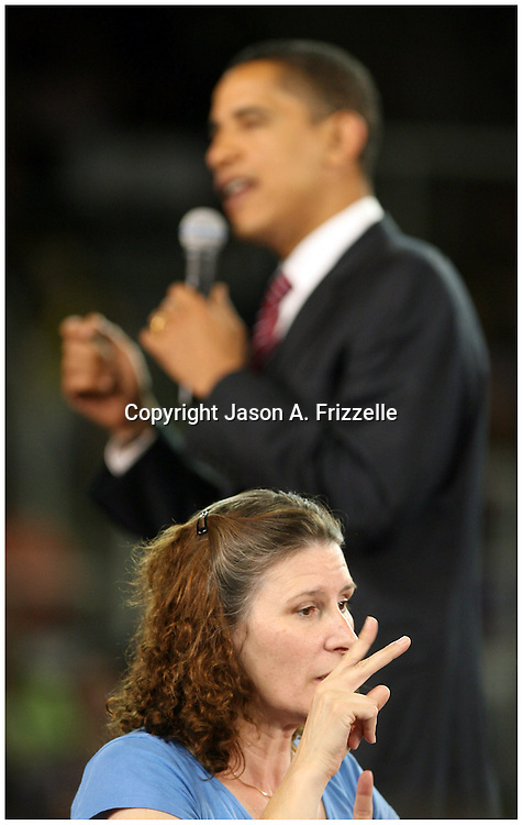 Greenville business owner Delia Liuzza signs for Presedential candidate Barack Obama's speech Thursday at Minges Coliseum in Greenville. (Jason A. Frizzelle)