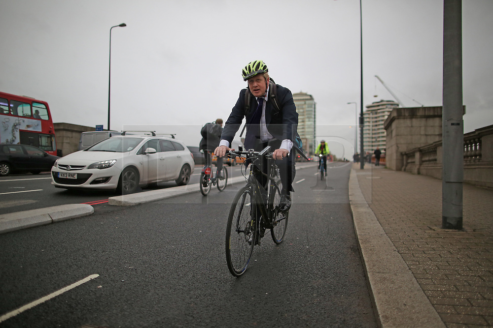 © Licensed to London News Pictures. 19/11/2015. London, UK. London Mayor Boris Johnson tries out the newly opened Cycle Superhighway 5 on Vauxhall Bridge. Dedicated cycle lanes are being installed throughout the capital. Photo credit: Peter Macdiarmid/LNP