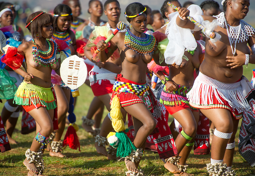 Ludzidzini, Swaziland, Africa - Annual Umhlanga, or reed dance ceremony, in which up to 100,000 young Swazi women gather to celebrate their virginity and honor the queen mother during the 8 day long event.<br />
Maidens dance before King Mswati III on day 7 of the ceremony