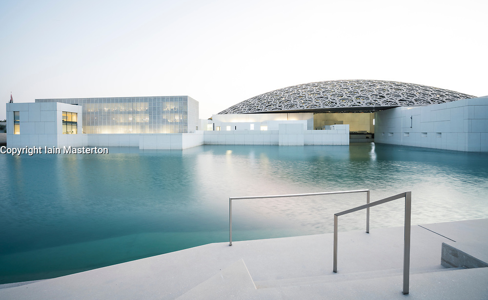 Exterior evening view of the Louvre Abu Dhabi at Saadiyat Island Cultural District in Abu Dhabi, UAE. Architect Jean Nouvel