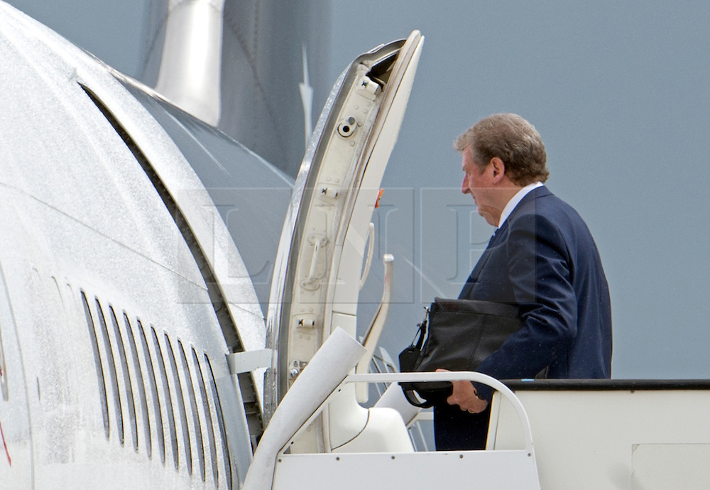 © London News Pictures. 06/06/2012. Luton, UK. England football team manager Roy Hodgson boarding a plane at Luton Airport in Bedfordshire on June 6, 2012 to head to Poland for the Euro 2012 football tournament. The squads training camp is based in Krakow. Photo credit: Ben Cawthra/LNP