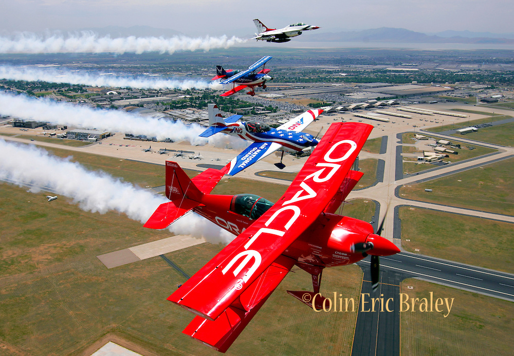 Stunt planes sponsored by the Air Force Reserve, the Air National Guard and Oracle, form up tight with an Air Force Thunderbirds F-16 during a photo shoot to promote an upcoming air show at Hill Air Force Base in Utah.