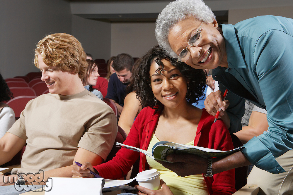 Teacher bending to couple of college students
